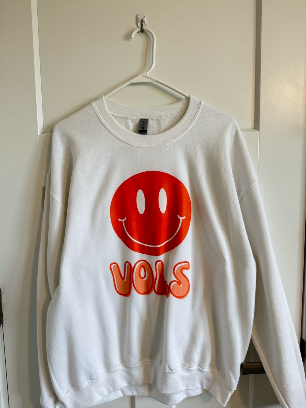 White Sweatshirt with Orange Smiley 'VOLS' Graphic
